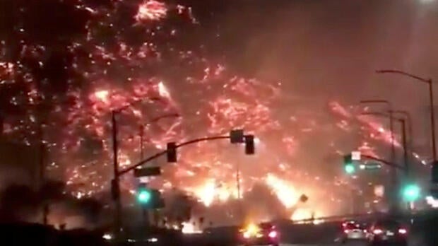 Flames of a wildfire are seen from the 405 highway in Los Angeles, California, Dec. 6, 2017, in this picture obtained from social media.