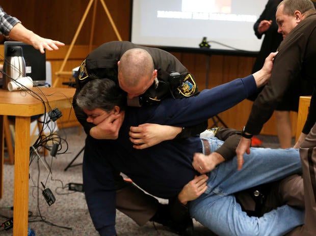 Eaton County sheriff's deputies restrain Randall Margraves after he lunged at Larry Nassar, a former USA Gymnastics team doctor who pleaded guilty in November 2017 to sexual assault charges, during victim statements in his final sentencing hearing in Eato