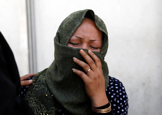 A woman mourns at a hospital after a suicide attack in Kabul