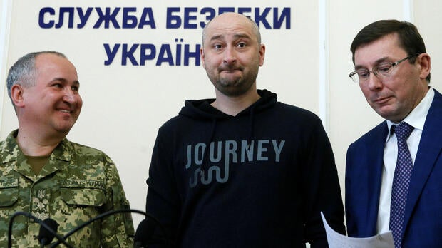Russian journalist Arkady Babchenko, center, who was reported murdered in the Ukrainian capital on May 29, 2018, Ukrainian Prosecutor General Yuriy Lutsenko, right, and head of the state security service Vasily Gritsak attend a news briefing in Kiev, Ukra