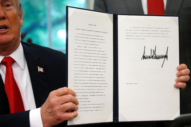 U.S. President Trump displays an executive order on immigration policy at the White House in Washington 
