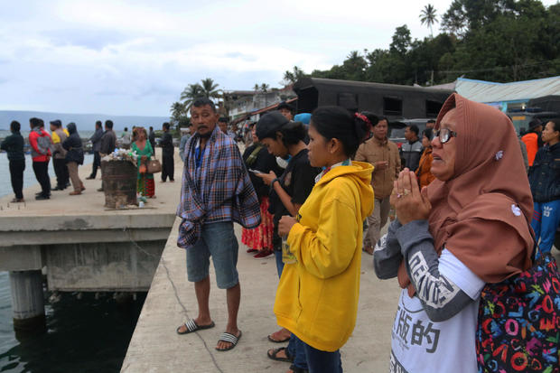 A woman prays for her son, a passenger on the KM Sinar Bangun ferry which sank yesterday in Lake Toba, in Simalungun, North Sumatra 