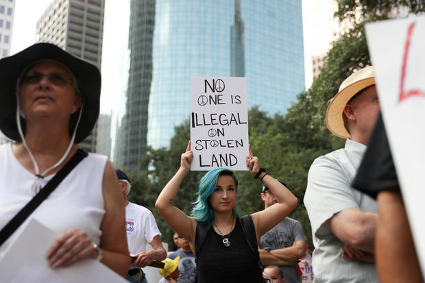 Demonstrators protest the Trump administration's immigration policies as part of a "Families Belong Together" rally in Houston 