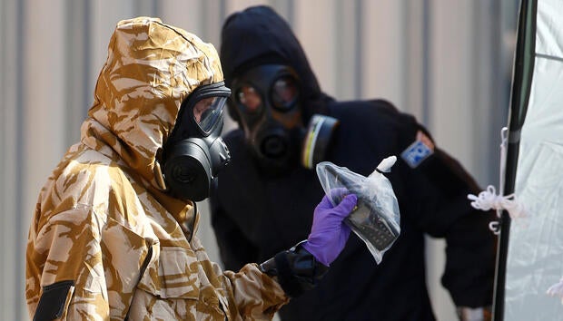 FILE PHOTO: Forensic investigators, wearing protective suits, emerge from the rear of John Baker House, after it was confirmed that two people had been poisoned with the nerve-agent Novichok, in Amesbury