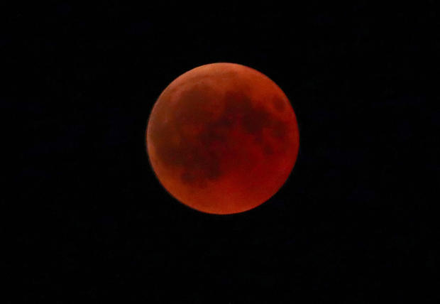 A "blood moon" is seen during a full lunar eclipse in the southern Bavarian village of Raisting 