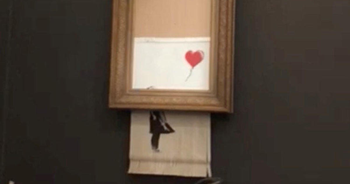 Banksy artwork self-destructs through shredder moment after $1.4 million sale
