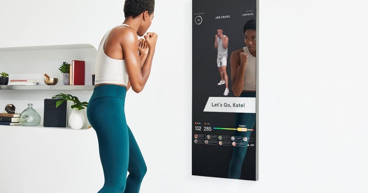 It looks like a mirror. But a personal trainer stares back at you when