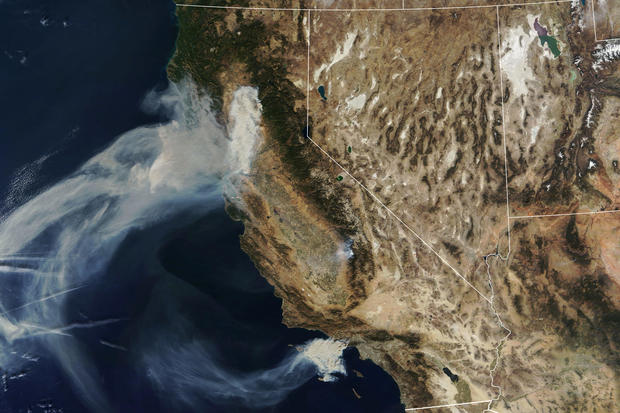 A NASA Terra satellite image shows smoke continuing to spread west from the Camp Fire and two more fires, the Hill and Woolsey Fires in southern California 
