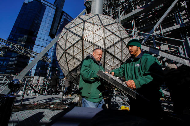 Workers prepare a panel of Waterford Crystal triangles before attaching it to the Times Square New Year's Eve Ball on the roof of One Times Square in Manhattan, New York 