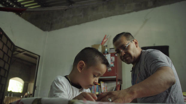 Rafa Arturo with his 5-year-old son Jacob at home in El Salvador.  CBS NEWS