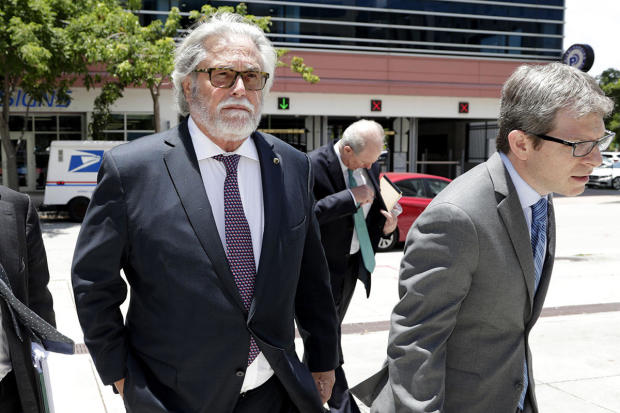 Carnival Corp. Chairman Micky Arison, left, arrives at federal court June 3, 2019, in Miami. 