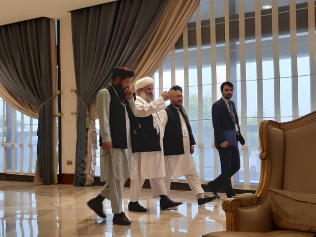 Members of Afghan delegations walk during the second day of  Intra-Afghan conference for peace in Doha 