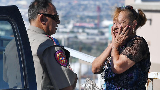 Virginia Chacon reacts as she tells her survival story to a police officer outside the Walmart where a shooting left 20 people dead in El Paso, Texas, on Aug. 4, 2019. 