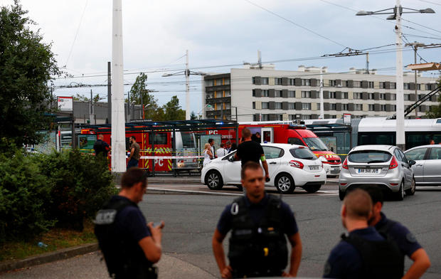 French police secure the area after one person was found dead and six others wounded in a suspected knife attack in Villeurbanne, near Lyon 