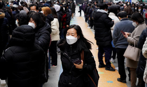 Lines form outside a department store selling masks in Seoul, South Korea, February 28, 2020.  (Credit: KIM HONG-JI/REUTERS)
