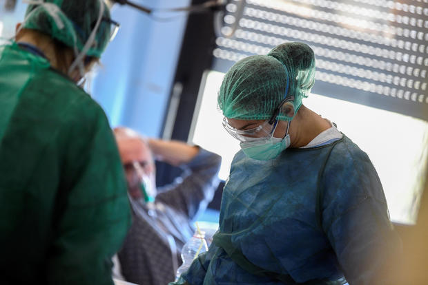 Medical staff wearing protective masks, glasses and suits treat patients suffering from coronavirus disease (COVID-19) in an intensive care unit at the Oglio Po hospital in Cremona 