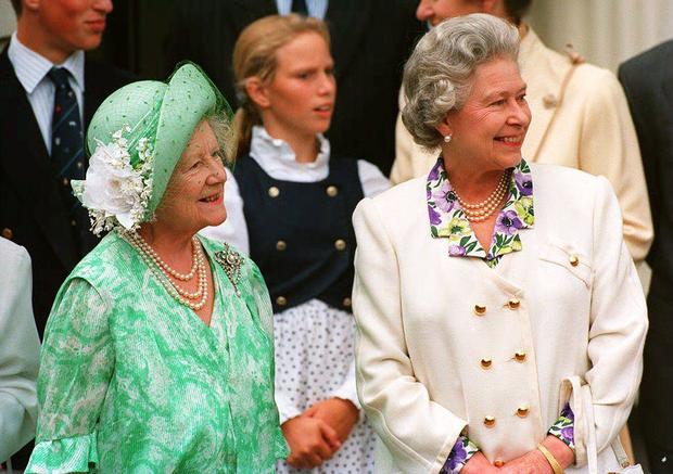 The Queen Mother (L) is joined by her el 