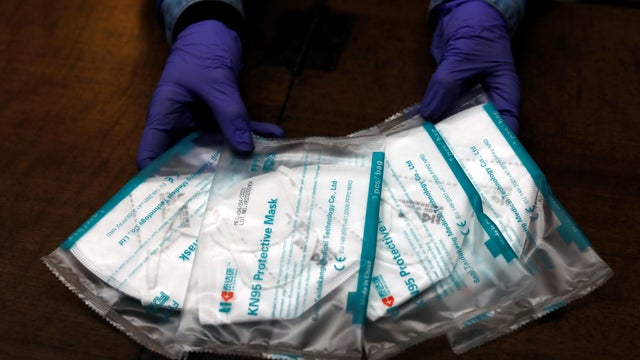 The employee of a pharmacy shows KN95 protective face masks, during the coronavirus disease (COVID-19) outbreak, in Ronda