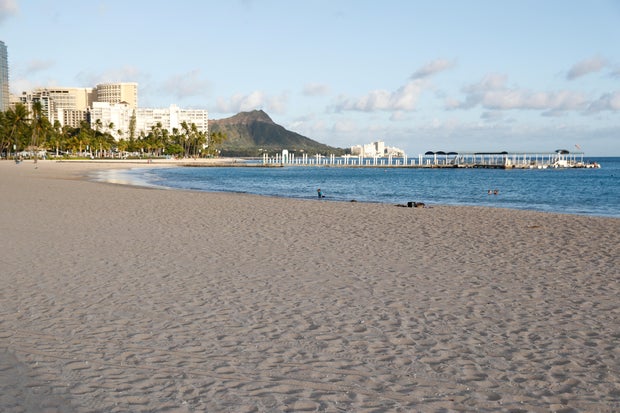 FILE PHOTO: Waikiki Beach is nearly empty due to the business downturn caused by the coronavirus disease (COVID-19) in Honolulu