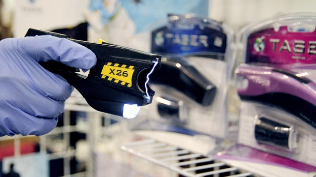 A sales person demonstates the Taser X26 