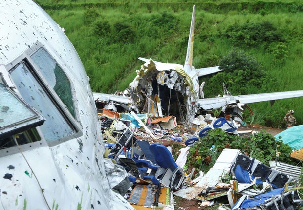 india A security official inspects the site where a passenger plane crashed when it overshot the runway at the Calicut International Airport in Karipur