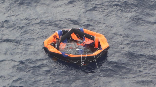 An aerial view taken from an airplane of Japan Coast Guard shows a Filipino crew member of the Gulf Livestock 1 on a life raft in the East China Sea 