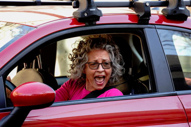 A woman cheers from her car after media announced that Democratic U.S. presidential nominee Joe Biden has won the 2020 U.S. presidential election in Madison 