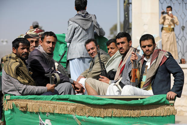 FILE PHOTO: Armed Houthi followers ride on the back of a truck after participating in a funeral of Houthi fighters killed in recent fighting against government forces in Yemen's oil-rich province of Marib, in Sanaa, Yemen 