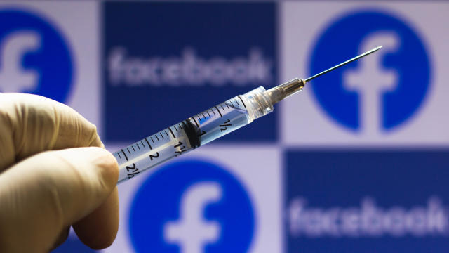 In this photo illustration a medical syringe seen with 
