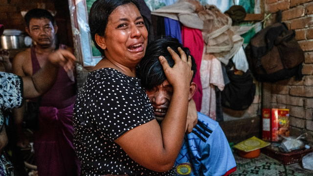 Family members mourn a man after he was shot dead during anti-coup protests, in Yangon 