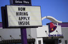 "Now hiring" sign outside Taco Bell 