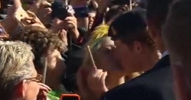 Prince Harry gets a surprise kiss from a fan