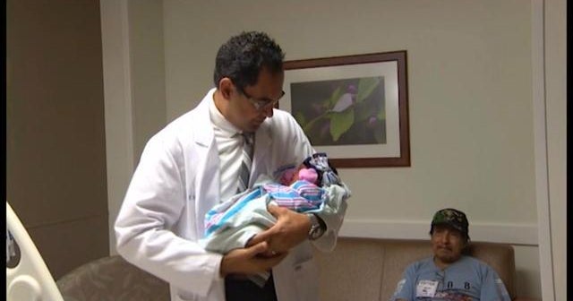 Doctor wades through flood to deliver babies