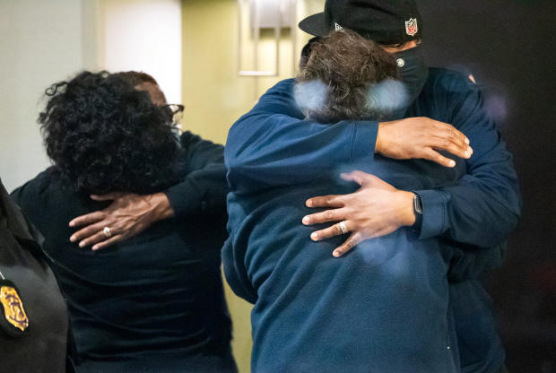 People embrace after learning their loved one was safe after a mass shooting at the FedEx facility in Indianapolis, Indiana, April 16, 2021. 