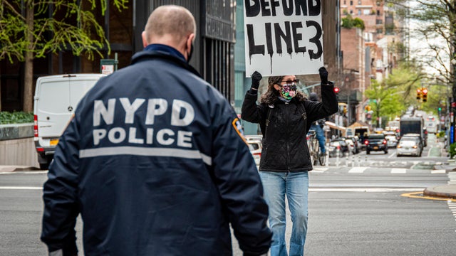 NYPD officer seen approaching a participant blocking a 