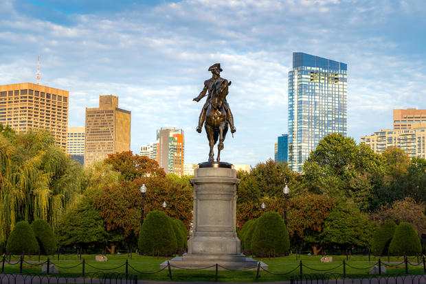 George Washington Equestrian Statue at Public Garden with office business building downtown district in Boston, Massachusetts, USA. USA tourism, modern city life, or business finance and economy concept 