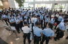 Police officers gather at the headquarters of Apple Daily in Hong Kong 