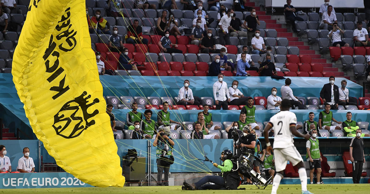 German police snipers had Greenpeace activist in sights as he crash-landed paraglider on soccer match