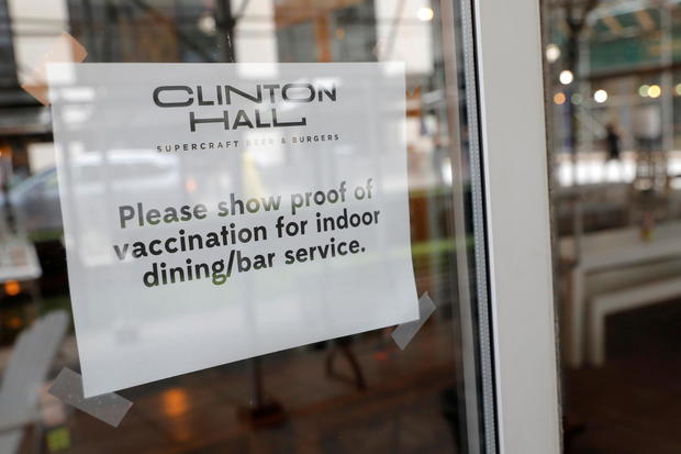 Signage is seen on a window in a restaurant as the vaccine mandate commenced during the outbreak of the coronavirus disease (COVID-19) in Manhattan, New York City 