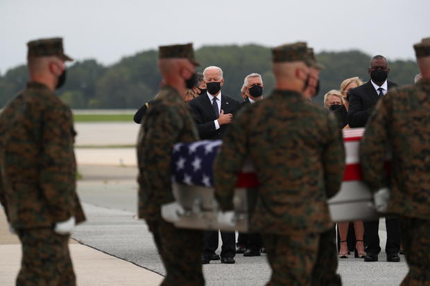 U.S. President Joe Biden salutes during the dignified transfer of the remains of U.S. Military service members who were killed by a suicide bombing at the Hamid Karzai International Airport 