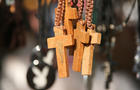 Close up of wooden crosses on rope necklaces 