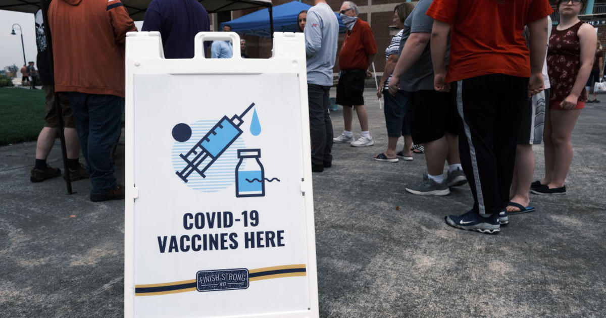 Fight over COVDI-19 vaccine booster shots heats up as cases surge in areas with low vaccination rates - CBS News