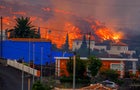 Lava flows behind houses following the eruption of a volcano in Spain 