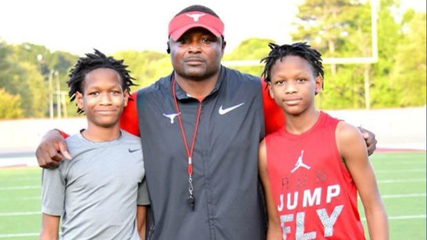 The Mathis twins and their dad, Claude Mathis 