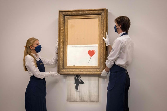 banksy artwork that self shredded sells for record 25 4 million at auction cbs news