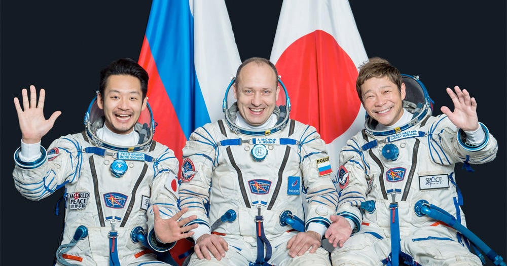 Russians launch Japanese billionaire on visit to space station