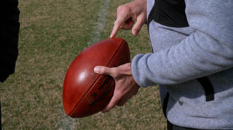 An NFL kicker's unique ball and shoes 