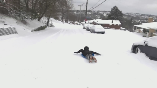 Child sleds on unplowed road in Overbrook 