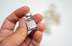 A health worker is holding a vial of Pfizer's Covid vaccine 