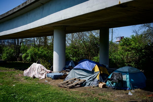 Multiple tents rest underneath an overpass in East Nashville.
